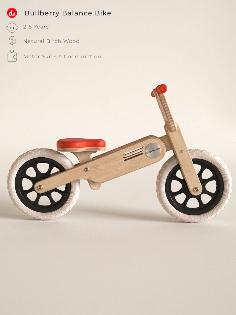 May include: A wooden balance bike with a red seat and handlebar grips. The bike has white tires and black wheels. The text "Bullberry Balance Bike" is at the top of the image. The bike is designed for children ages 2-5.