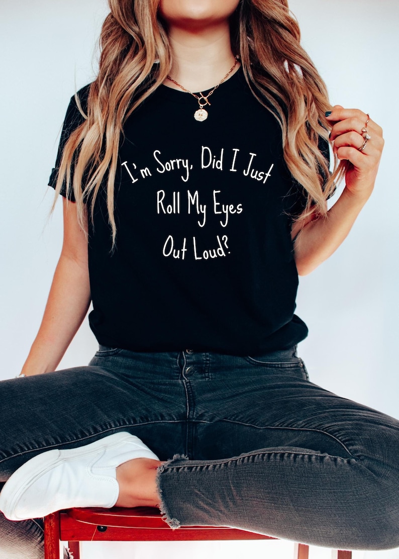 Black T-shirt with humorous "I'm Sorry, Did I Just Roll My Eyes Out Loud?" text, worn by a seated woman.