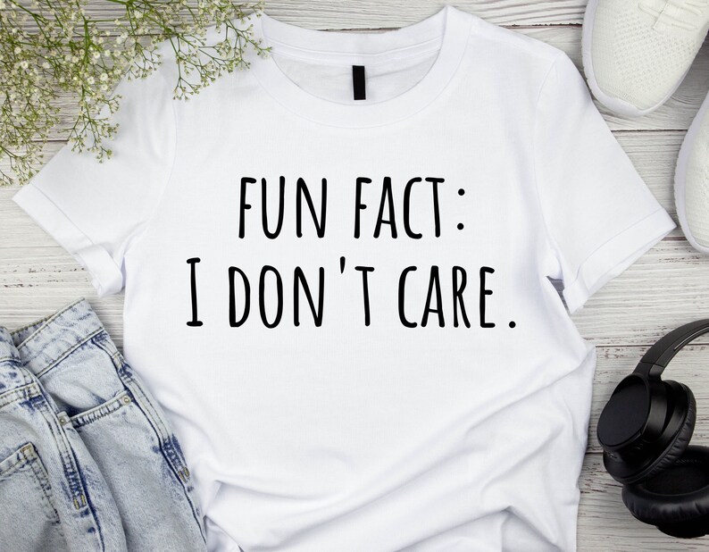 May include: White t-shirt with black text that reads "Fun Fact: I Don't Care."