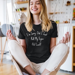 Trendy black T-shirt with sarcastic "Roll My Eyes" quote for teen girls, casual wear, humorous apparel.