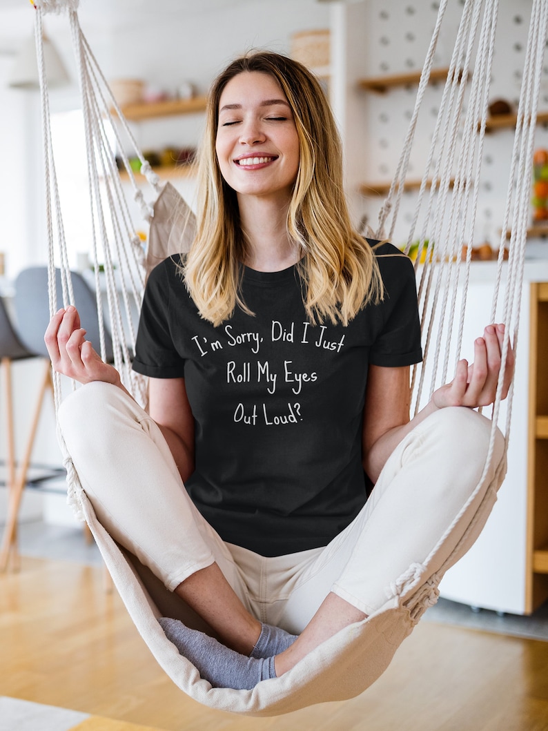 Trendy black T-shirt with sarcastic "Roll My Eyes" quote for teen girls, casual wear, humorous apparel.