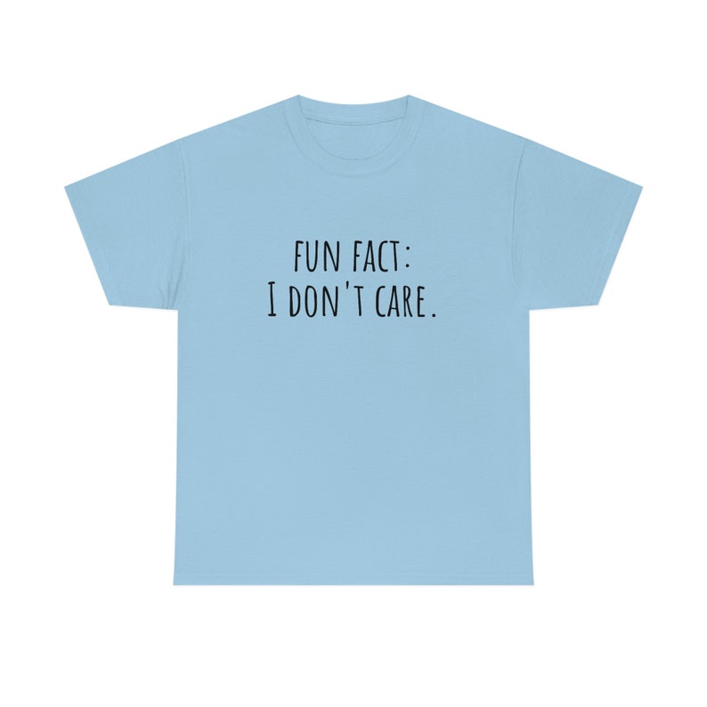 May include: A light blue t-shirt with the text "FUN FACT: I DON'T CARE." printed in black.