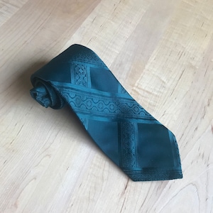 May include: A dark green patterned tie with a geometric design.