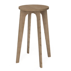 May include: A wooden stool with a round top and three legs. The stool is made of light brown wood and has a natural finish.
