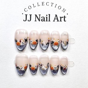May include: A set of ten press-on nails labeled JJ Nail Art Collection. Each nail features a nude base with a silver glitter gradient tip and various Halloween-themed decals including pumpkins, skulls, spiders, bats, bones, and witch hats.