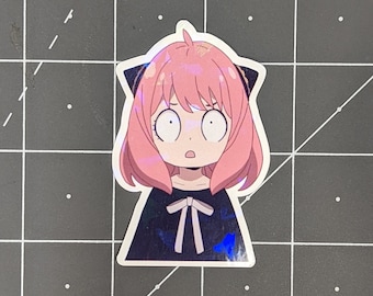 Pode incluir: Um adesivo de um personagem de anime com cabelo rosa, olhos grandes e uma expressão de surpresa. O personagem está vestindo um vestido preto com um laço branco.