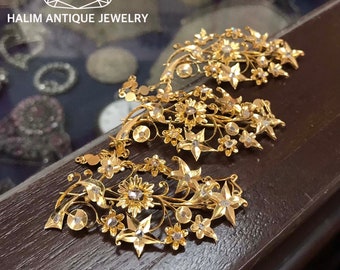 A gorgeous set of three antique gold brooches set with polki diamonds with patterned chains.