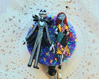 May include: A purple glitter badge reel featuring Jack Skellington and Sally from The Nightmare Before Christmas.