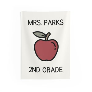 May include: A white background with black text that reads "MRS. PARKS 2ND GRADE". A red apple with a green leaf is in the center of the text.