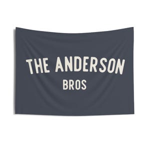 May include: A dark blue banner with white text that reads "THE ANDERSON BROS."