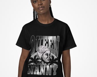 May include: Black t-shirt with a graphic design featuring the word "QUEEN" above the word "NANNY". The design includes an illustration of a woman wearing a head wrap and palm trees.