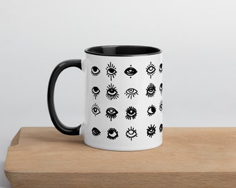 Glossy white mug with black colored interior - an eye for an eye