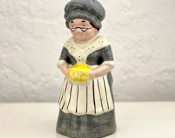 Vintage ceramic figurine of an older woman baker - Grandma is baking a cake