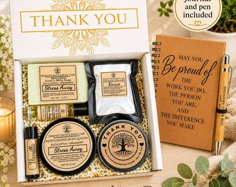 May include: A gift box containing a bar of goat's milk soap, a shower steamer, a small bottle of oil, a container of body lotion, a vanilla lip balm, and a candle. Beside the box is a spiral-bound journal and a pen with the text FOR BEING AWESOME.