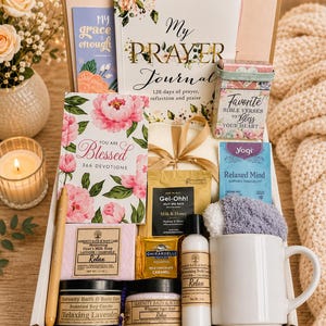 May include: A gift box containing a My Prayer Journal, a You Are Blessed devotional, a Favorite Bible Verses box, a Relaxed Mind tea bag, a Gel-Ohh! bath packet, a Ghirardelli chocolate square, a white mug, a pen, and Serenity Bath & Body products.
