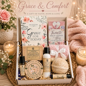 May include: A gift box containing a Grace for Today devotional book, a Favorite Bible Verses card, a bar of goat's milk soap, a bottle of body lotion, a body oil roller, a scented soy candle, a bath bomb, a vanilla lip balm, and fuzzy socks.