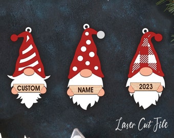 May include: Three red and white gnome ornaments with wooden signs. The signs read "CUSTOM", "NAME", and "2023".