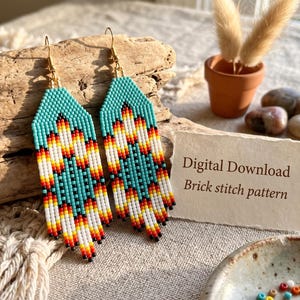 May include: A pair of beaded earrings featuring a geometric pattern in turquoise, white, yellow, orange, and red. The earrings have gold-tone hooks. A card next to the earrings displays the text Digital Download Brick stitch pattern.