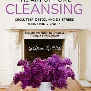 May include: A book cover with the title "THE ART OF HOME CLEANSING" in large purple letters. Below, text reads "DECLUTTER, DETOX, AND DE-STRESS YOUR LIVING SPACES." A vase of purple flowers sits on a wooden table in front of a fireplace.