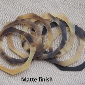May include: A set of six octagonal horn bangles with a matte finish. The bangles are stacked on top of each other, showing the different sizes and colors of the horn.