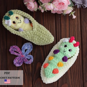 May include: Two crocheted plush toys shaped like caterpillars inside pea pods, one yellow and one green, with a small purple crocheted butterfly. The image includes text that reads PDF CROCHET PATTERN with a small American flag icon.