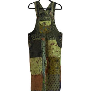 May include: Green patchwork denim dungarees with a variety of printed designs, including mushrooms and flowers.
