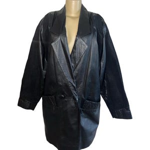 May include: Black leather blazer with a notched collar, two front pockets, and a single-button closure. The sleeves have a textured pattern. The blazer is displayed on a mannequin.