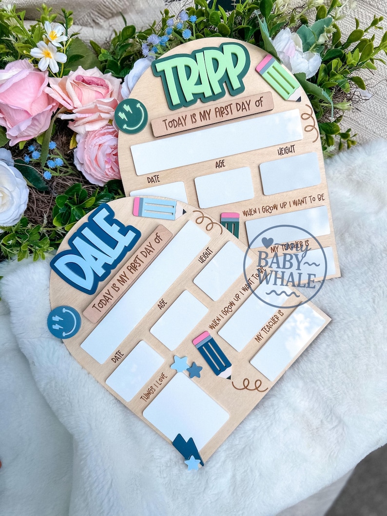 May include: Two wooden first day of school signs. One sign has the name "TRIPP" in green, the other has "DALE" in blue. Both signs have spaces for date, age, weight, and "when I grow up I want to be". Decorative elements include pencils and smiley faces.