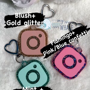May include: Three Instagram-themed keychains with different glitter colors and designs. The first keychain is pink with gold glitter and says "Blush + Gold glitter". The second keychain is pink with pink and blue glitter and says "Flamingo + Pink/Blue confetti". The third keychain is mint green with teal glitter and says "Mint + Teal Glitter".