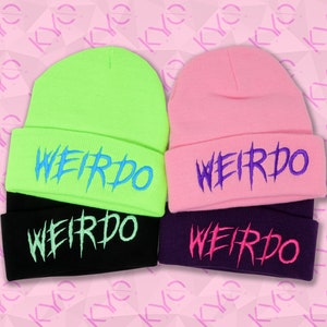 May include: Two beanie hats with the word "WEIRDO" embroidered on them. The hats are black, pink, and neon green with blue and purple embroidery.