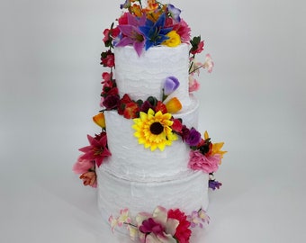 Wedding cake piñata, with vibrant cascading flowers, and ideal party game to add smiles & laughter to your wedding reception entertainment