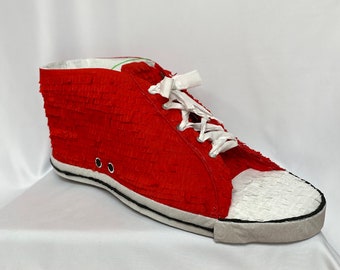 Classic, red, high-top trainer piñata, the perfect party accessory to celebrate a stylish fashionista's birthday party