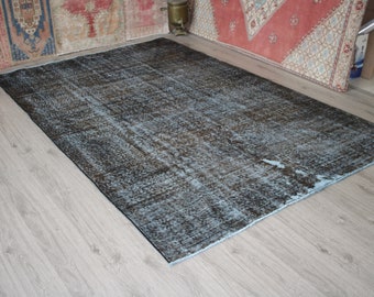 May include: A vintage distressed rug with a blue and brown color scheme. The rug has a faded, worn look and is made of a soft, textured material.