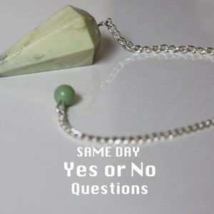 May include: A green crystal pendulum with a silver chain and a green bead. The text "SAME DAY Yes or No Questions" is written below the pendulum.