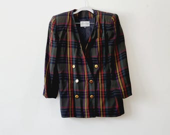 May include: A vintage plaid blazer in a mix of colors, including green, red, yellow, and purple. The double-breasted jacket features gold-colored buttons and is displayed on a white hanger against a white background.