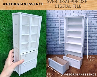 May include: A white miniature cabinet with two glass-paneled doors, four interior shelves, and two bottom drawers. The digital file includes SVG, CDR, AI, PDF, and DXF formats. The cabinet measures 33 cm or 13 inches high and 13 cm or 5 inches wide.