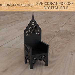 May include: A black wooden chair with a tall, pointed back and intricate carvings. The chair has a seat and four legs.