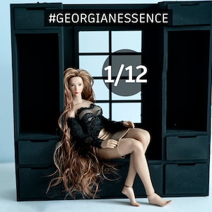 May include: A 1/12 scale doll with long brown hair wearing a black lace top and a gold skirt, sitting on a black wooden shelf with the text "#GEORGIANESSENCE" above it.