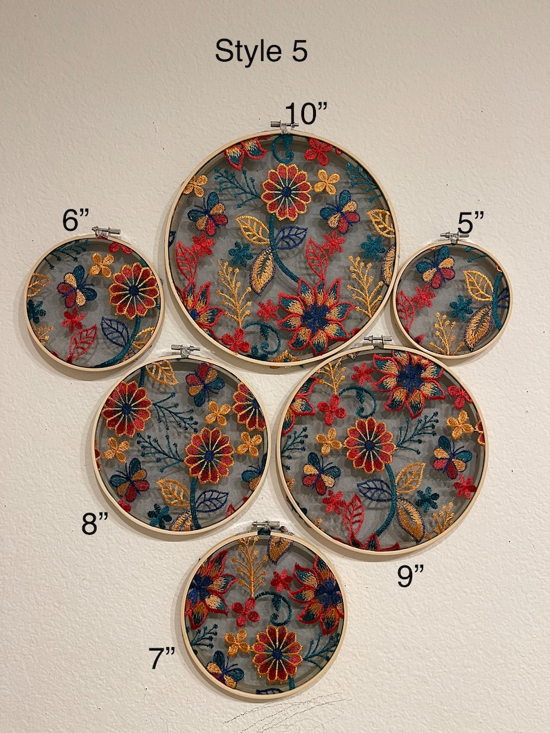 May include: A set of six embroidery hoops with floral designs in shades of red, yellow, and blue. The hoops are different sizes, ranging from 5 inches to 10 inches in diameter. The text "Style 5" is written at the top of the image.