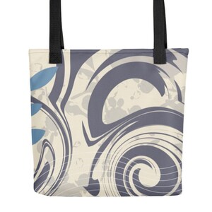 May include: A tote bag with black handles and a cream and grey abstract swirl pattern. The pattern includes blue accents.