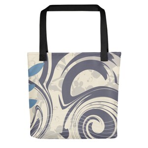 May include: A tote bag featuring a swirling abstract design in shades of grey and white. The design includes a blue leaf pattern on the left side of the bag.