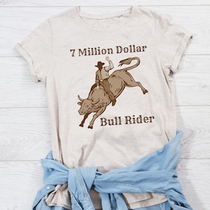 7 Million Dollar Bull Rider | JB Mauney | Womens | Mens | Kids | Shirt | Rodeo | Bull Riding | He&#39;s a Seven Million Dollar Bull Rider