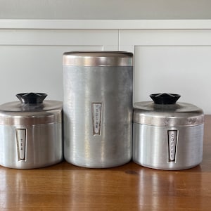 Vintage Westbend aluminium jerrycans: roségouden en zwarte keukenopbergers