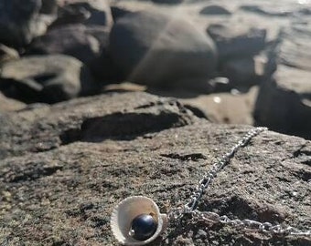 Aurora shell and natural, black, peacock, fresh water pearl pendant.