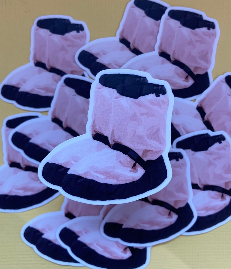 May include: A stack of pink and black waterproof shoe covers. The shoe covers are made of a crinkled material and have a black elastic band around the top.