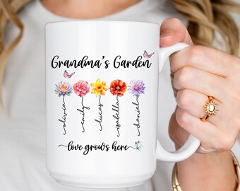 May include: White ceramic mug with the text "Grandma's Garden" and a butterfly design. Five flowers with names written underneath each flower: Olivia, Emily, Lucas, Isabella, and Daniel. The text "Love grows here" is written below the flowers.