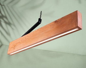 May include: A modern wooden pendant light fixture with a black metal arm and chain. The light has a rectangular wooden body with a thin, integrated LED light strip.