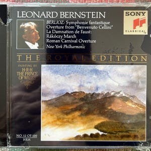 May include: A set of three ceramic mugs with a speckled, matte finish. The mugs are in shades of cream, light gray, and dark gray. Each mug has a simple, minimalist design and a rounded handle. The mugs are stacked on top of each other.