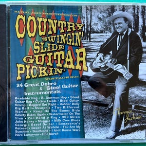 May include: A vintage CD case with the title "Country Swingin' Slide Guitar Pickin'" featuring a man playing a guitar. The cover includes text listing 24 instrumental songs. The CD case is in a clear plastic case.