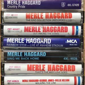 May include: A collection of six cassette tapes featuring country music artist Merle Haggard. The tapes are all in their original cases and have a variety of album titles, including "Country Pride", "The Epic Collection (Recorded Live)", "Out Among The Stars", "Rainbow Stew - Live At Anaheim Stadium", "Sing Me Back Home", and "That's The Way Love Goes".